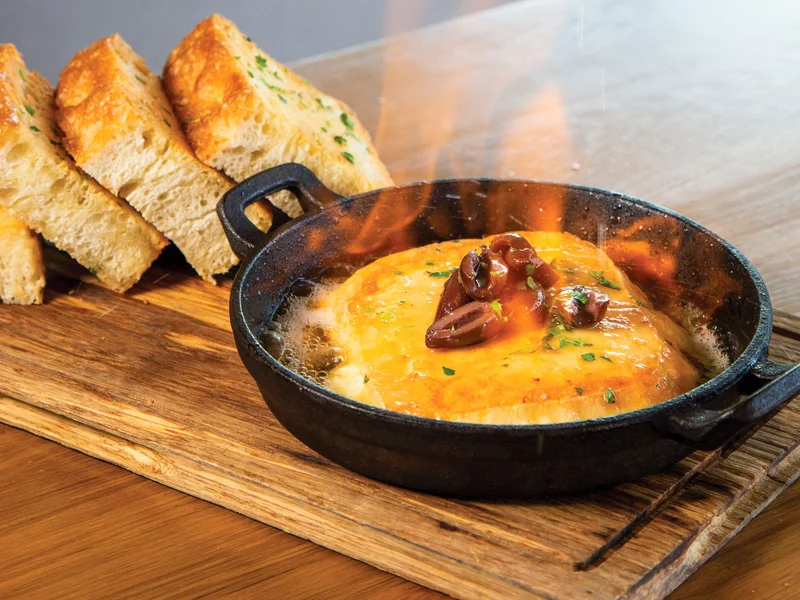 Saganaki - Pan-seared Greek cheese flambéed tableside with fresh lemon