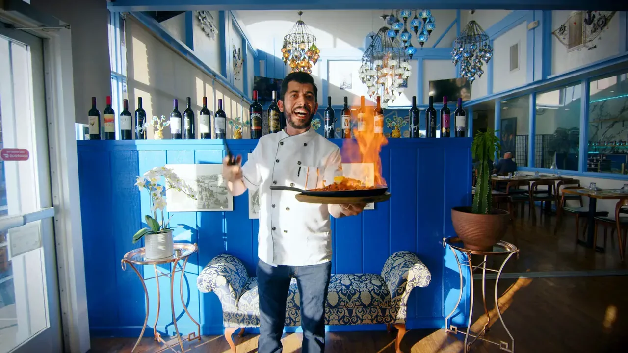 Chef Ilyas Kara flambéing Saganaki tableside at Kalimera Bar & Grill
