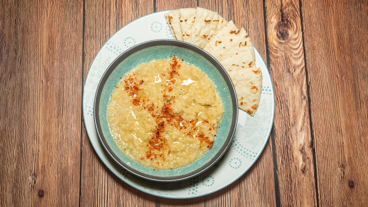 Baba Ganoush - Smoky roasted eggplant blended with tahini, herbs, and Italian parsley — a Mediterranean classic.