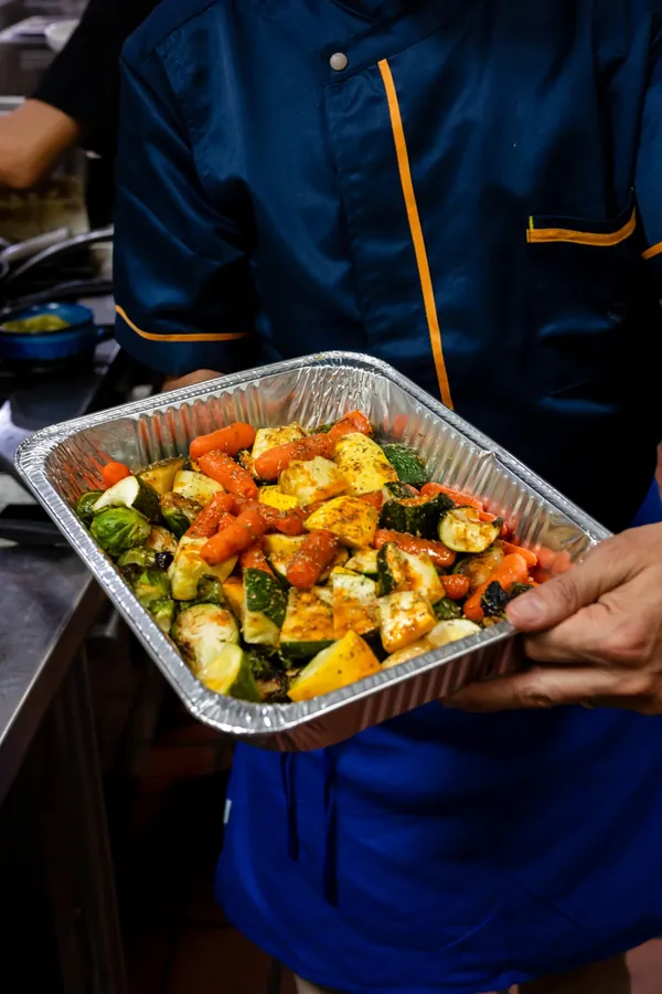 Roasted carrots, zucchini, squash and Brussels sprouts in a catering tray
