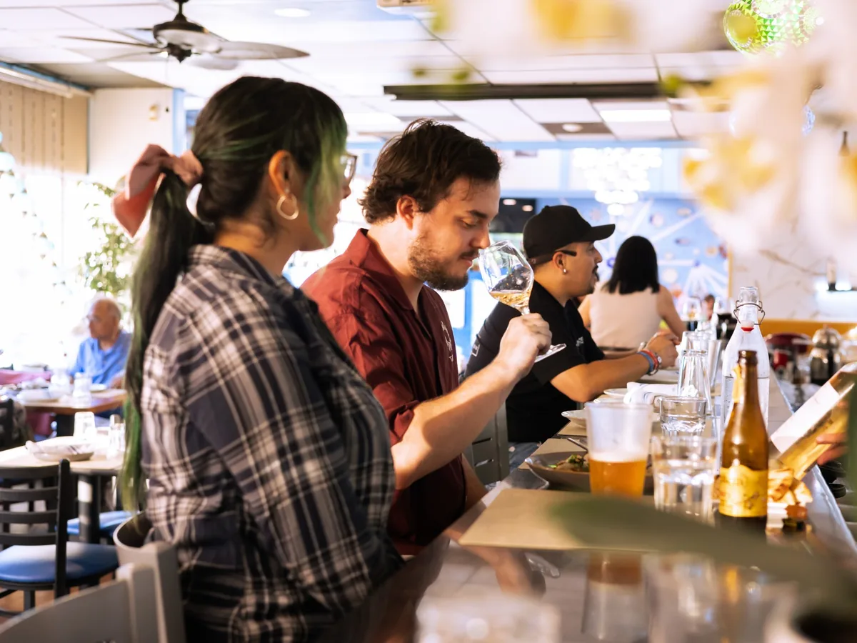 Guests sharing wine and small plates at the Kalimera bar in Santa Rosa