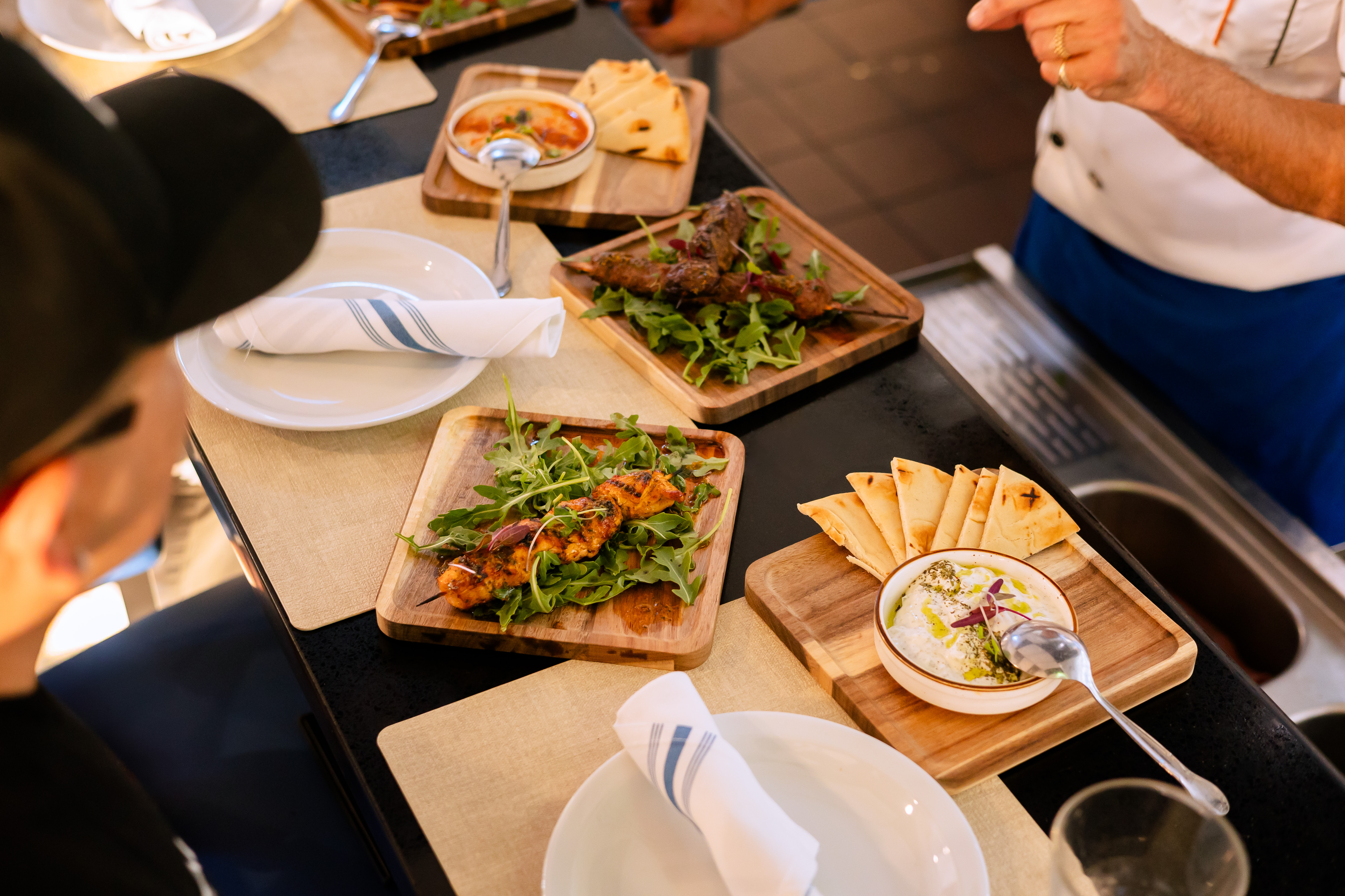Small plates and shareables laid out for two at Kalimera Bar & Grill